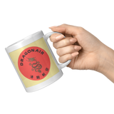 Dragonair_Vintage_Bag_Sticker_11oz_Coffe_11oz_White_RH_Model_Mockup.png_16313482