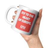 LTU_Fly_to_the_Heart_of_Europe_Vintage_B_11oz_White_LH_Model_Mockup.png_16309231