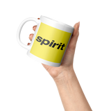 Spirit_Airlines_Black_on_Yellow_Coffee_M_Lifestyle_Raised_Hand_LH_Mockup.png